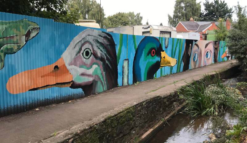  mural on corrugated iron fence ross on wye by tom and laurie cousins 2024